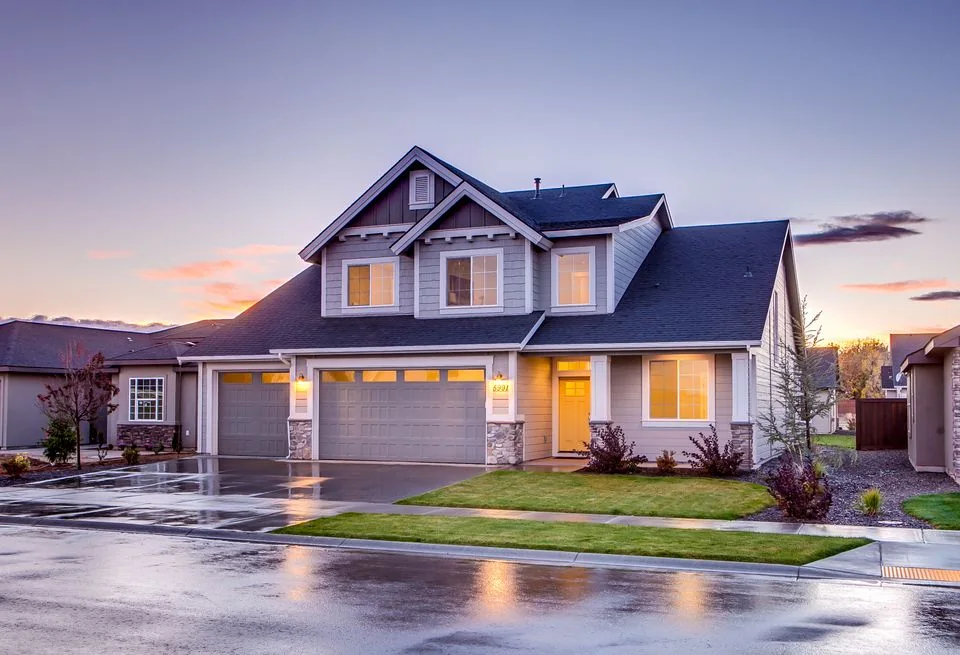 Two-story home with gray lap siding at dusk.